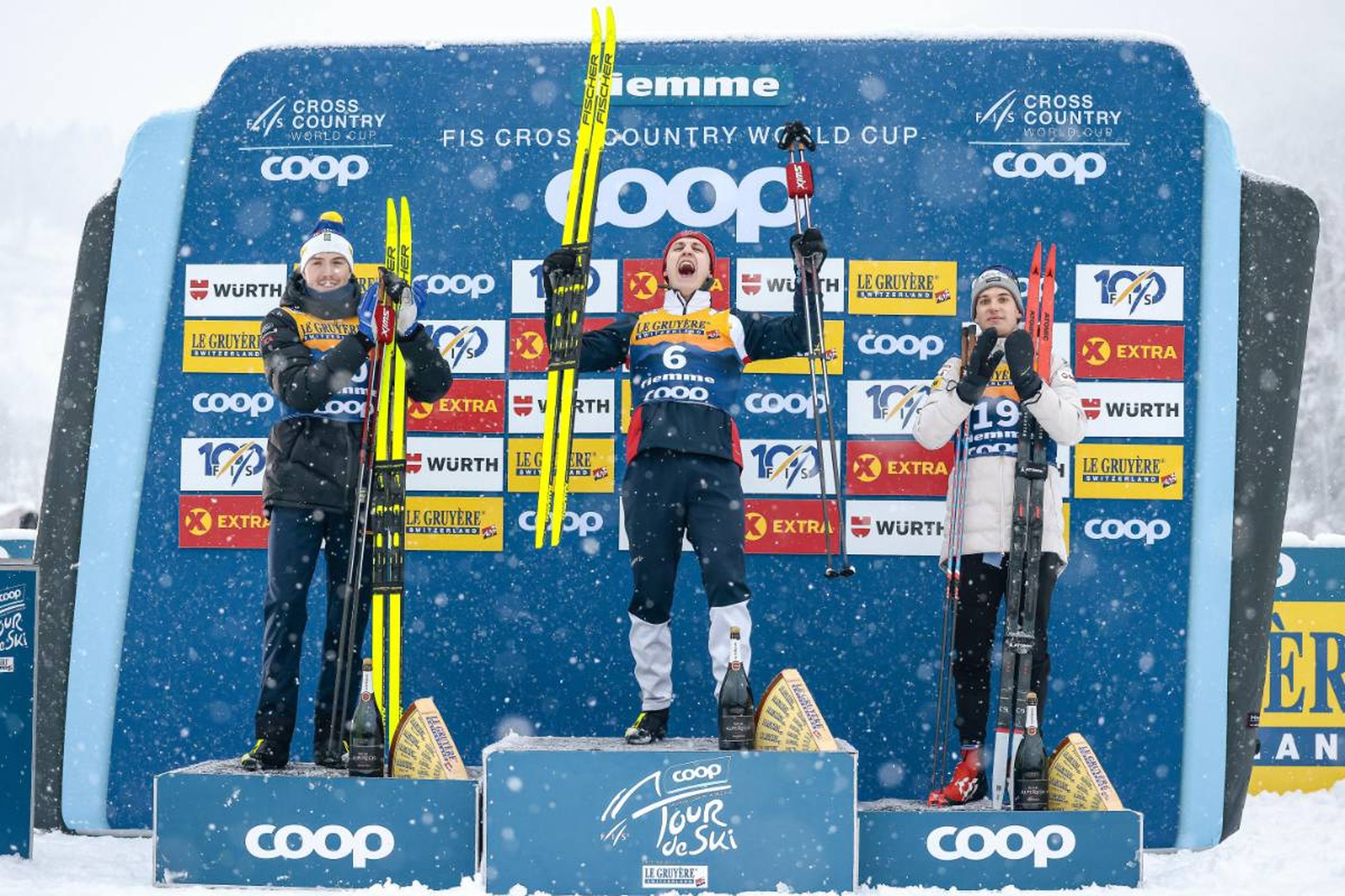 Three winners: Sweden's William Poromaa (left), Norway's Erik Valnes (centre) and Switzerland's Cyril Faehndrich (right) all had lots to celebrate after reaching the men's 15km mass start classic podium  © NordicFocus