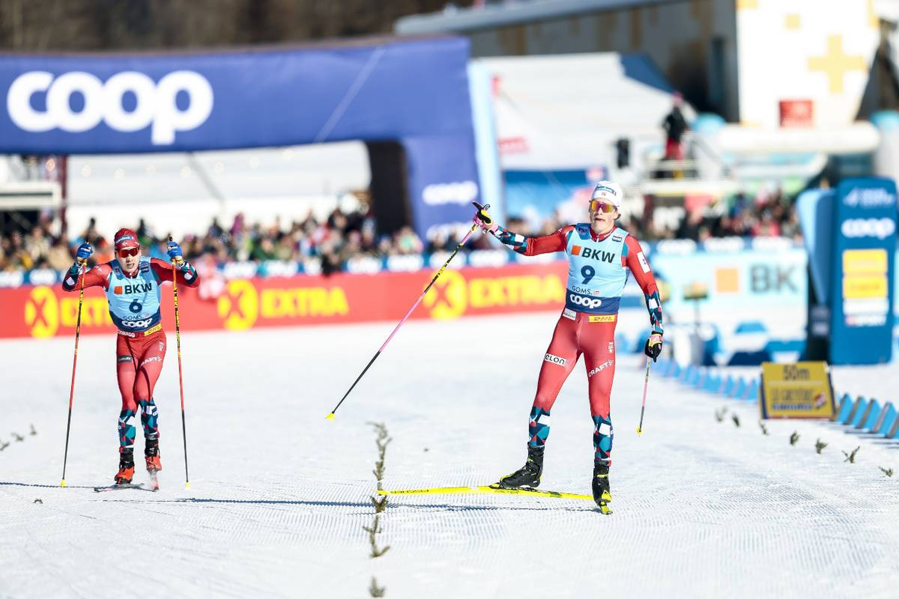 Simen Hegstad Krueger (left) watches on as Johannes Hoesflot Klaebo (right) celebrates his victory before crossing the finish line © NordicFocus