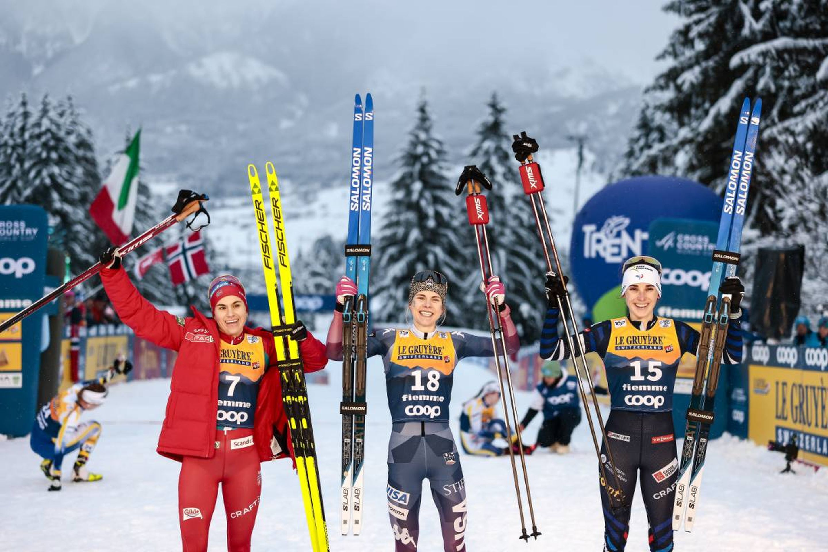 Norway's Heidi Weng (left), USA's Sophia Laukli (centre) and France's Delphine Claudel (right) smile on the last podium of the 2023/24 Tour de Ski © NordicFocus