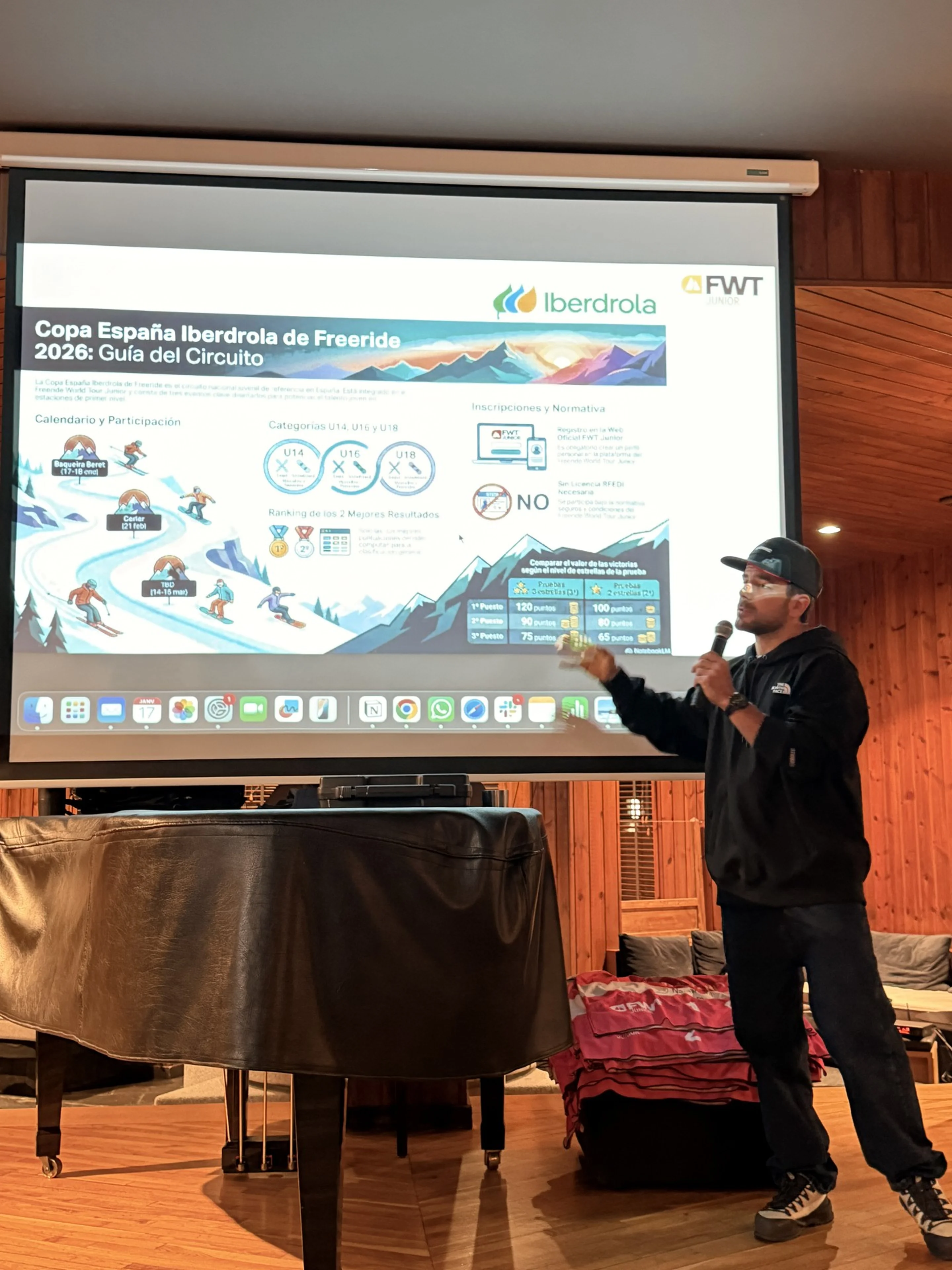 Navarro speaks in front of a Powerpoint presentation