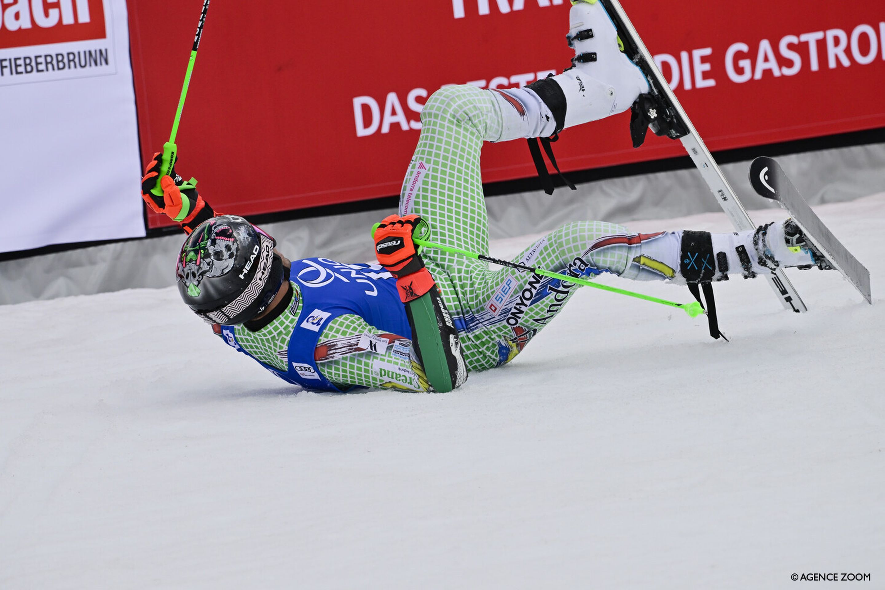 Joan Verdu (AND) rolls around in the snow in celebration after taking the lead