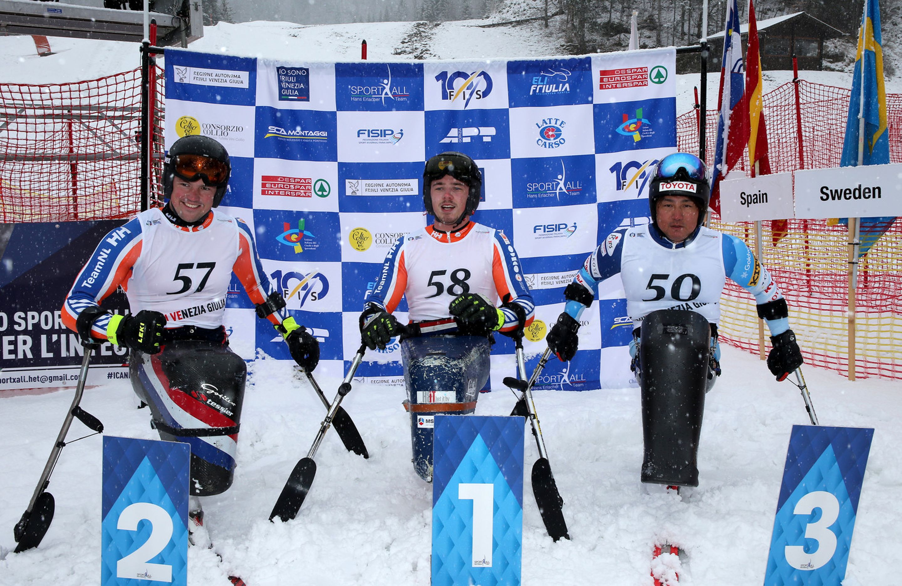 Niels De Langen (NED), Jeroen Kampschreur (NED) and Taiki Morii (JPN) in the finish area after the second run of the last giant slalom in Sella Nevea