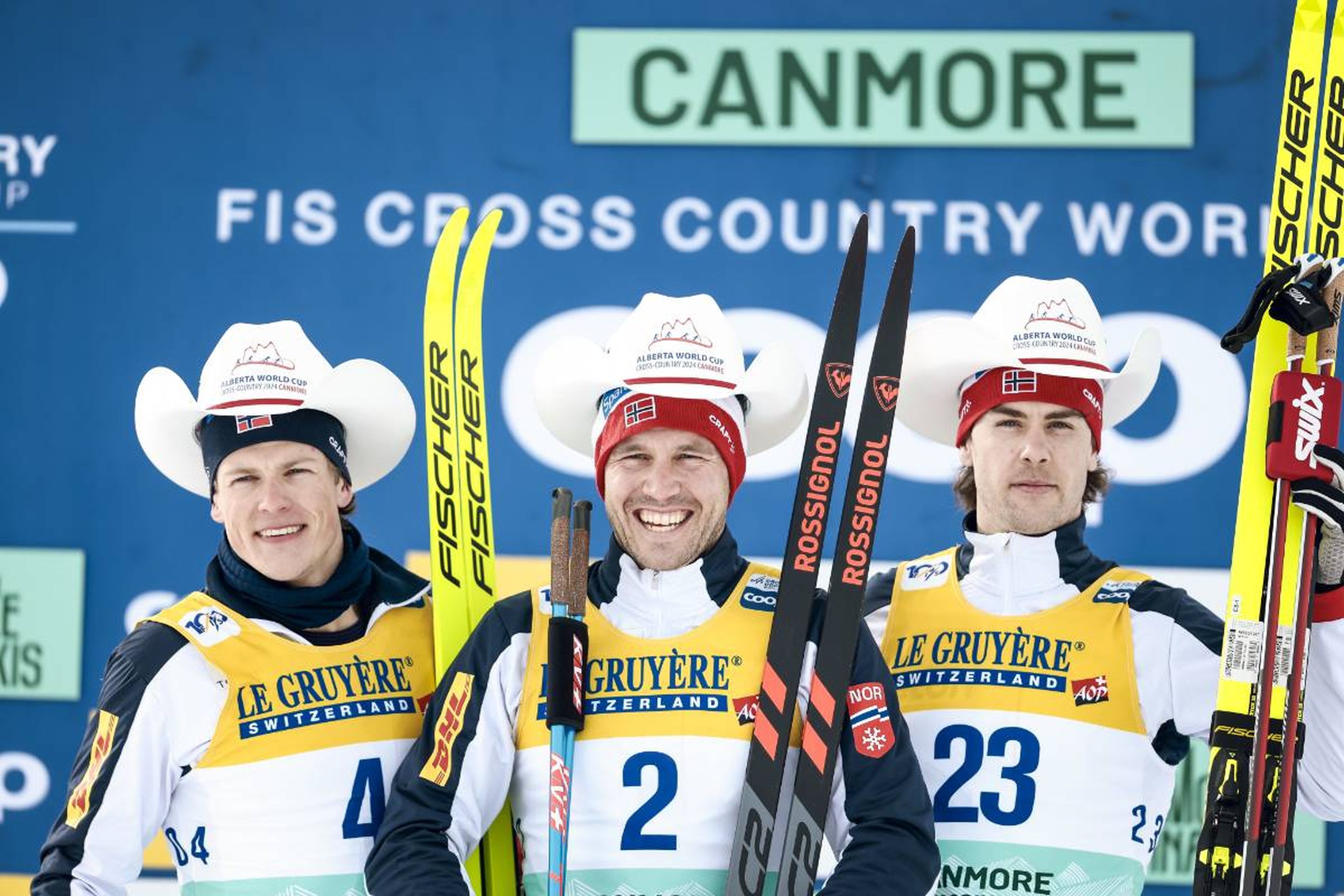 Norway's Johannes Hoesflot Klaebo (left), Paal Golberg (centre) and Mattis Stenshagen (right) celebrate on the podium © NordicFocus