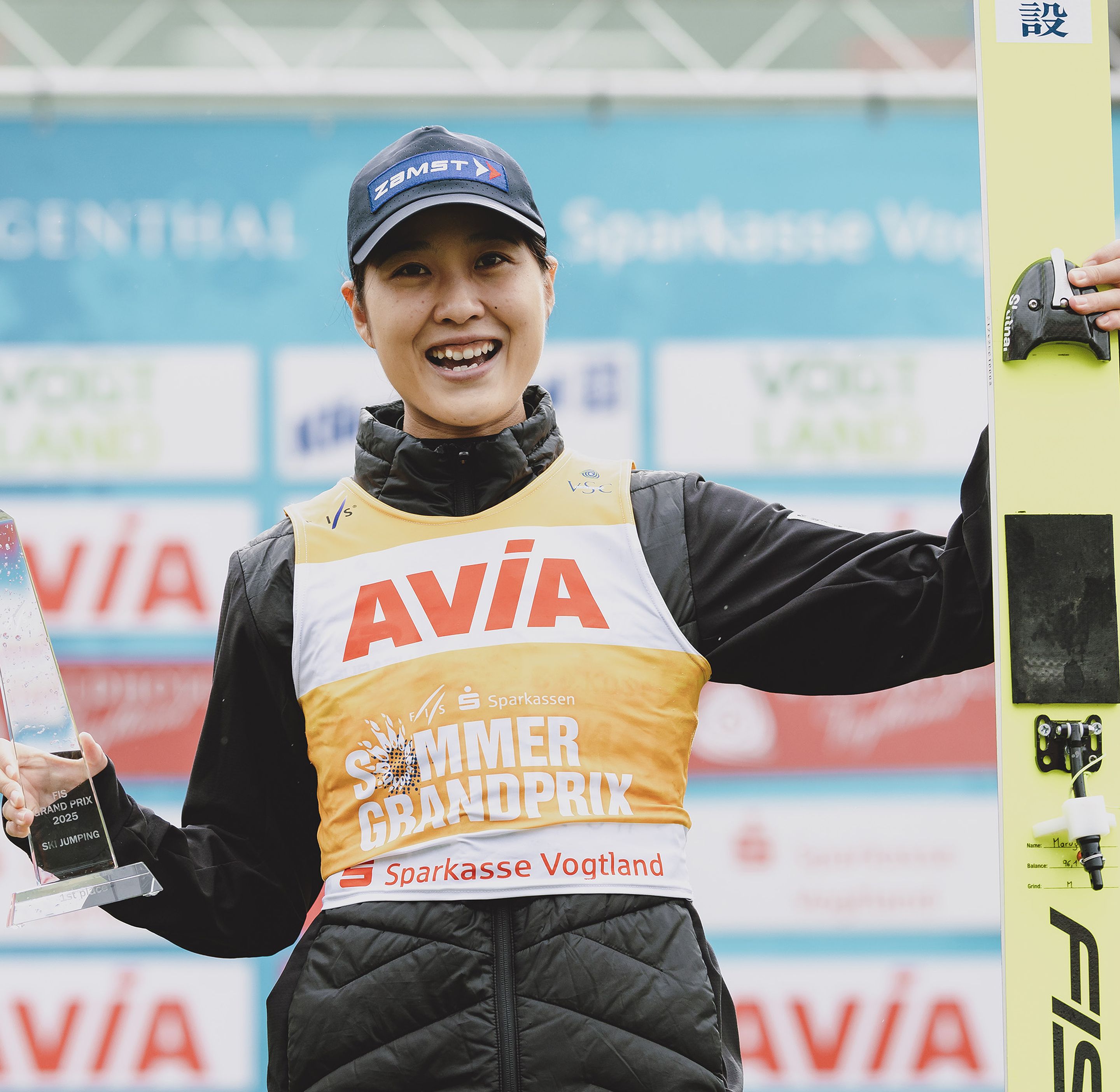 Maruyama smiles as she holds the trophy