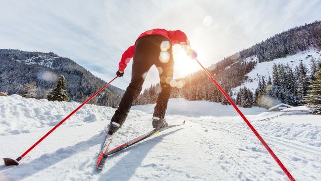 Cross-country skiing. Young man doing outdoor exercise.
