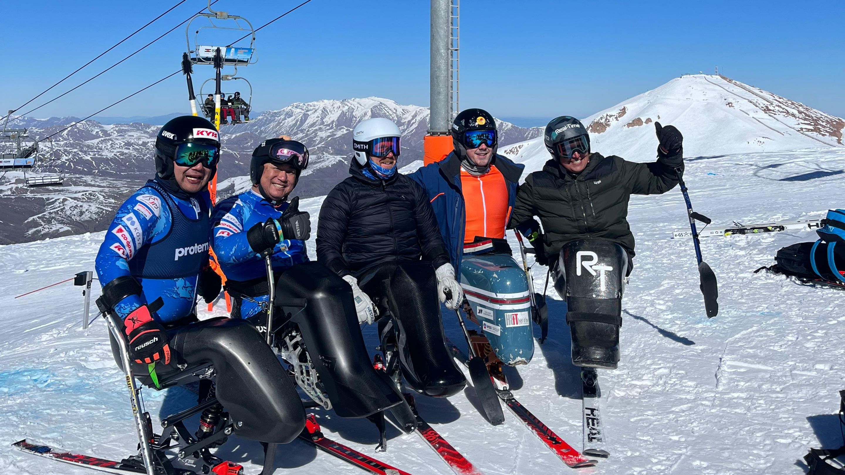 Five sit ski athletes pose for photos