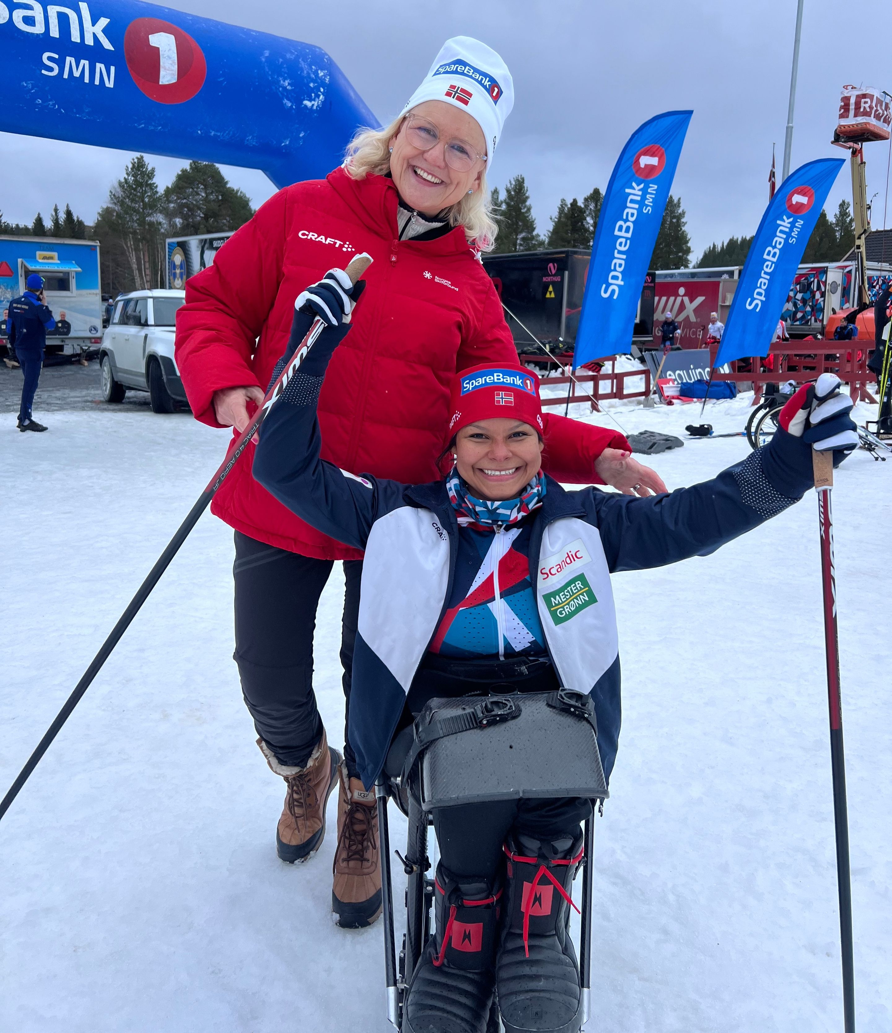 Para cross-country sit-skier with an able-bodied person
