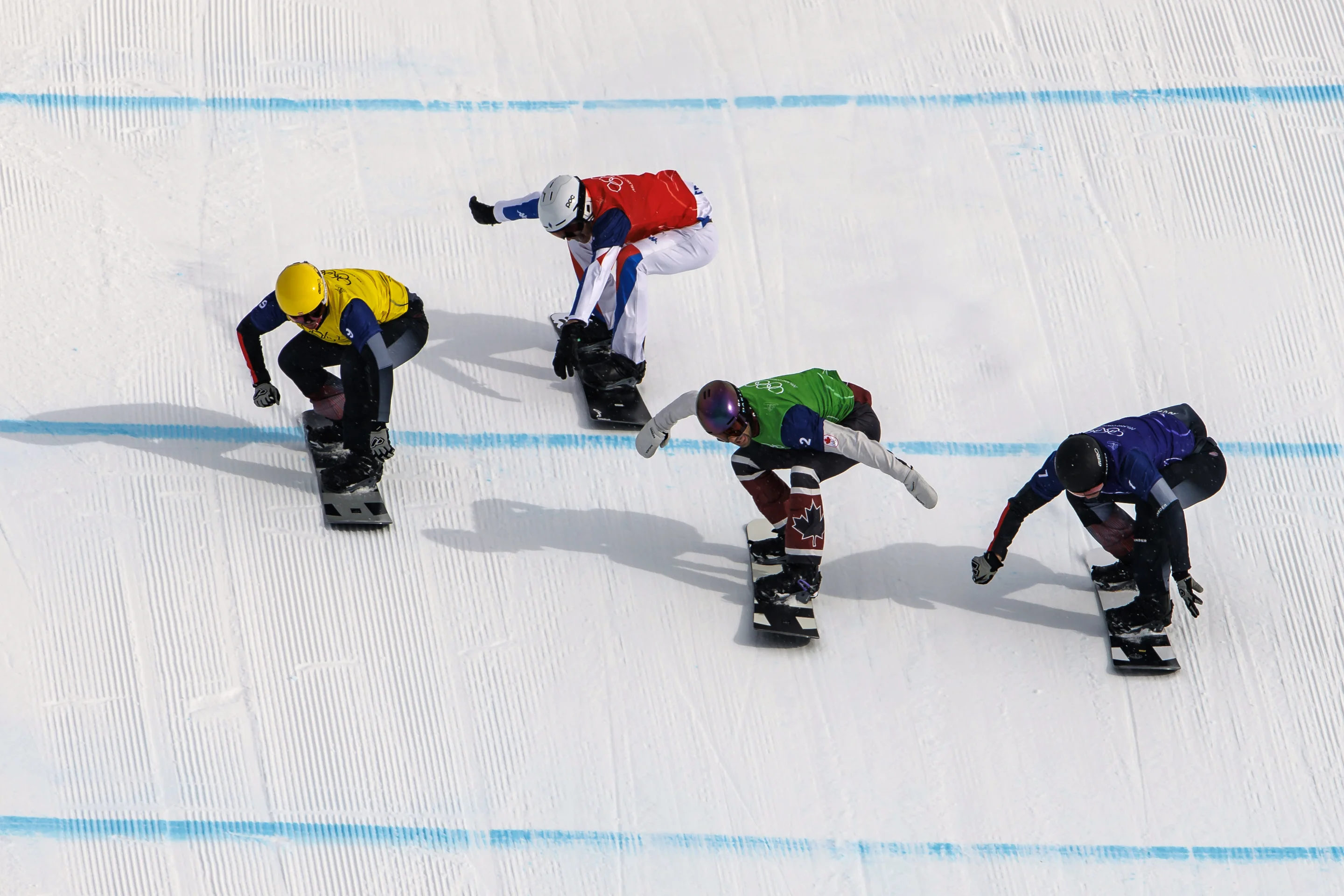 Jakob Dusek, in a yellow bib, passes Aidan Chollet, in a red bib, just before the finishing line