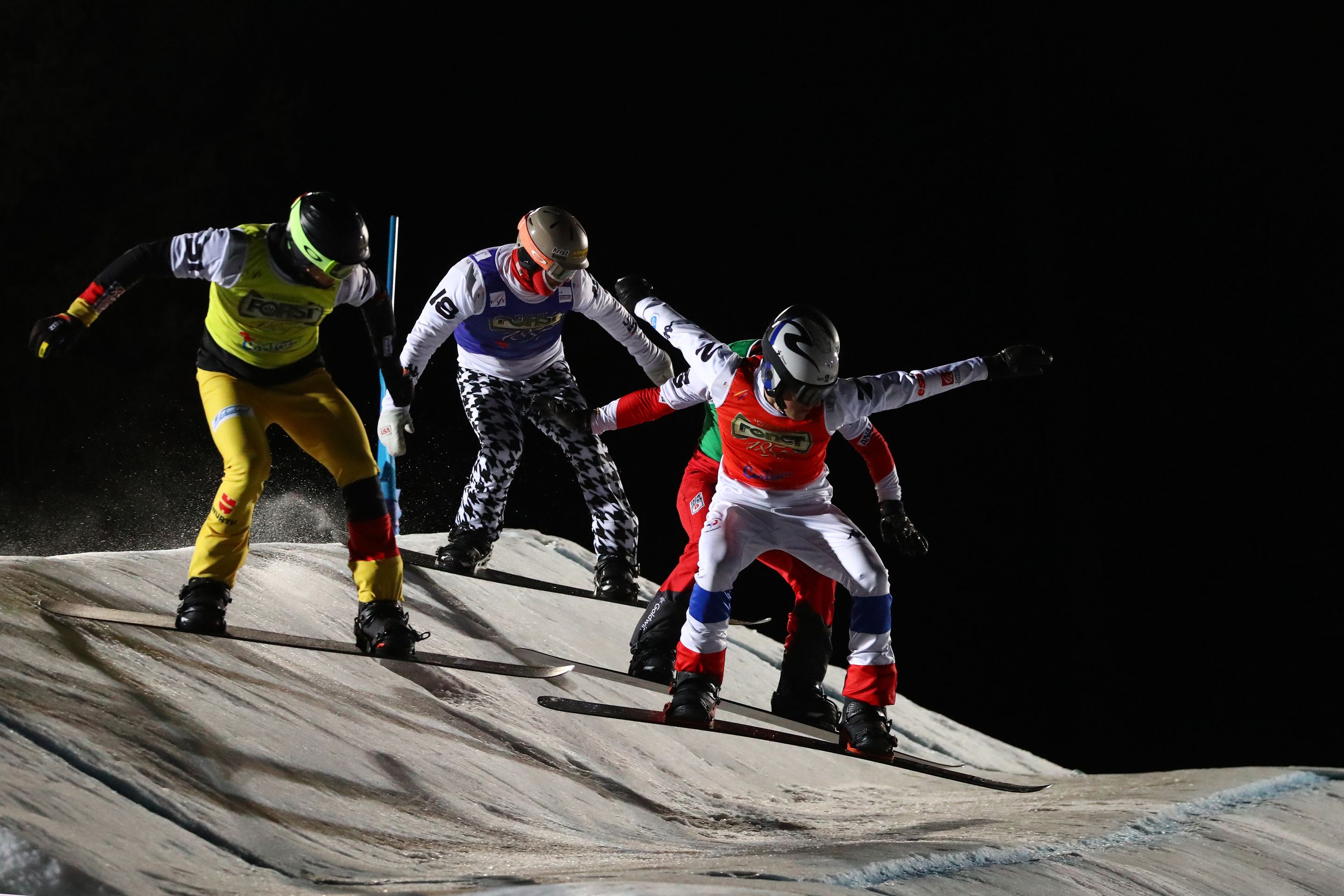Snowboard cross athletes race under lights in Cortina D'Ampezzo
