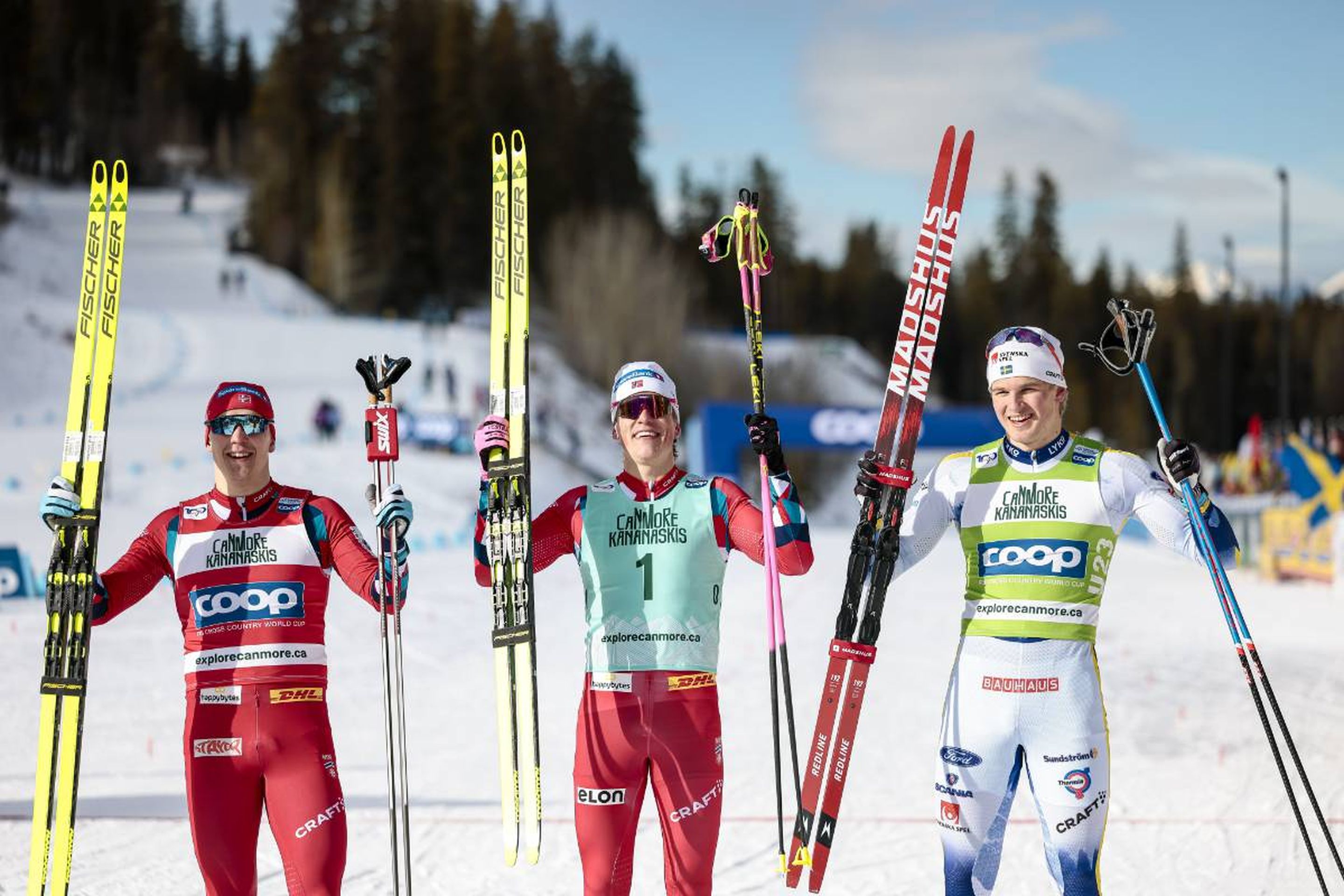 Norway's Erik Valnes (left) and Johannes Hoesflot Klaebo (centre) celebrate their top-three finish with Sweden's Edvin Anger (right) © NordicFocus