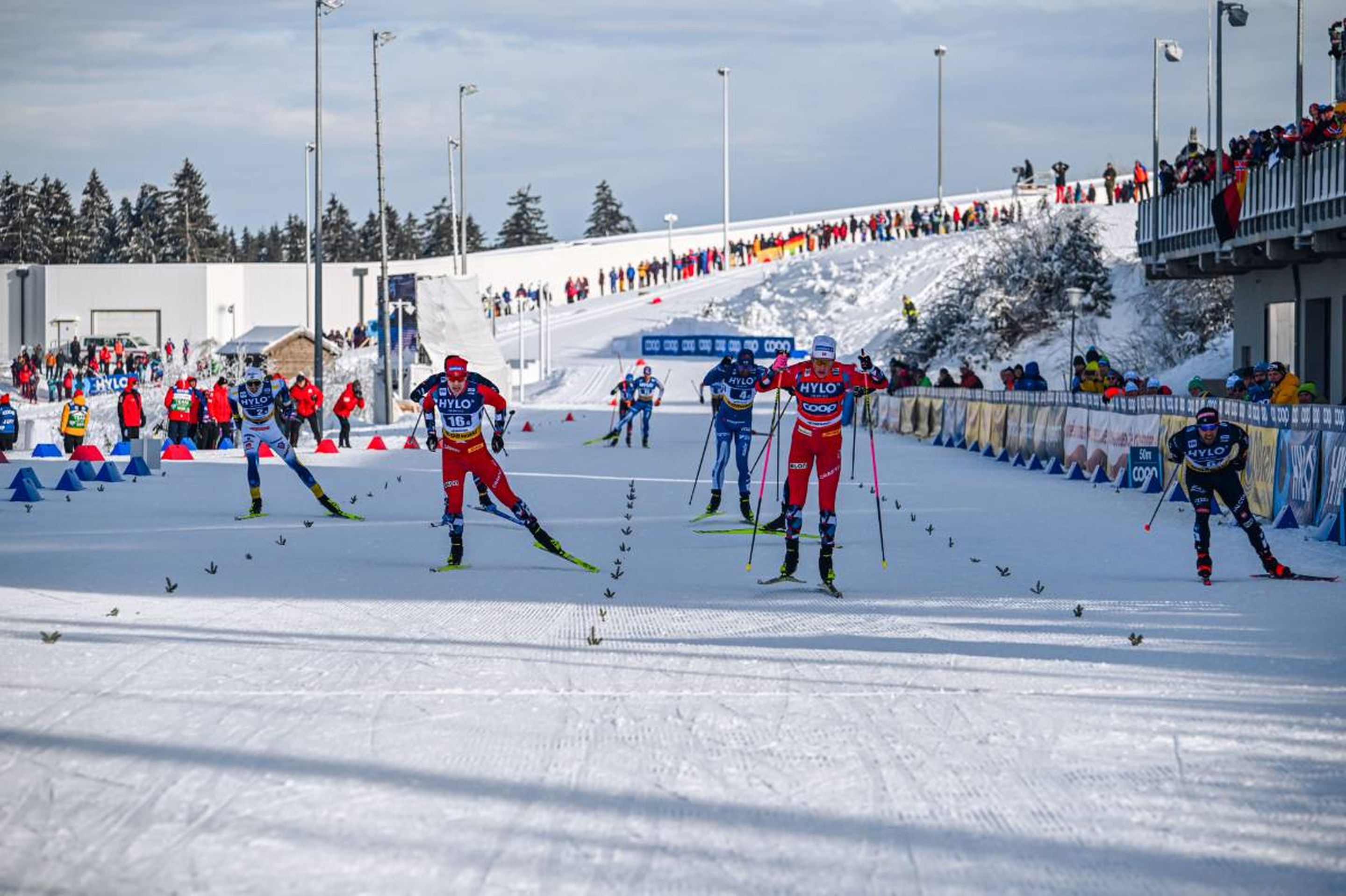 Drama into the last metres of the 30km race: Norway II's Mattis Stenshagen (left), Norway I's Johannes Hoesflot Klaebo (middle) and Italy’s Federico Pellegrino (right) battle it out for the relay first place © NordicFocus