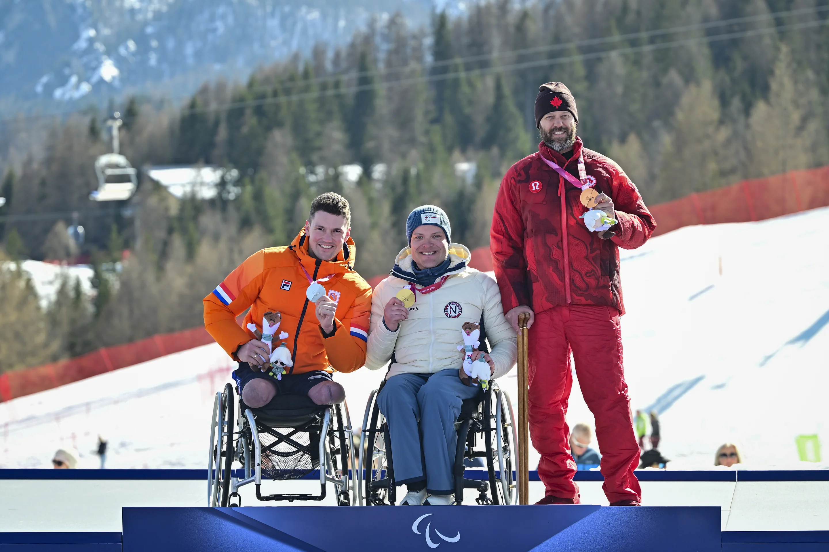 Niels de Langen (NED), Jesper Pedersen (NOR), and Kurt Oatway (CAN) share the podium at Milano Cortina 2026
