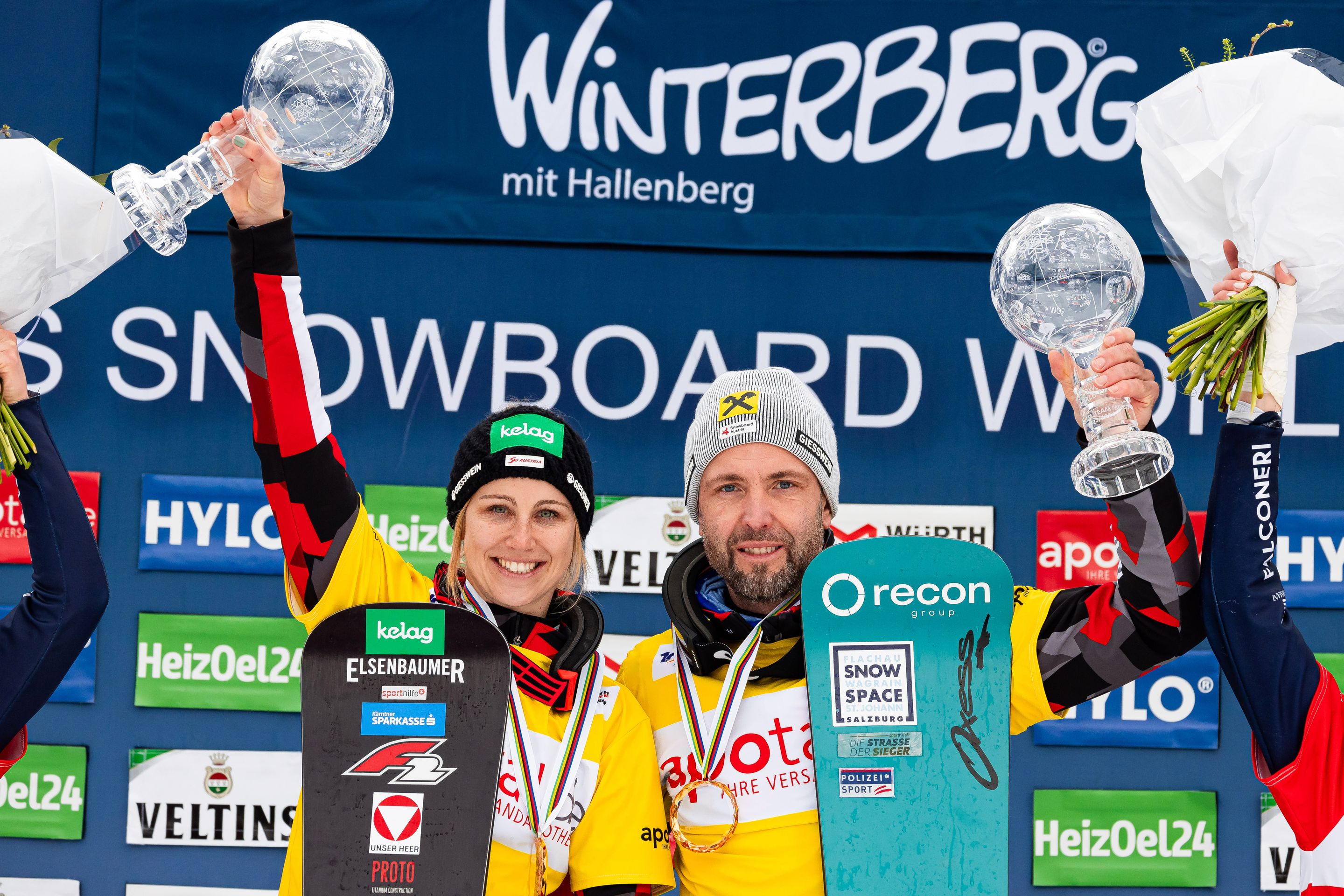 Sabine Schoeffmann (AUT) & Andreas Prommegger (AUT) raise crystal globes.