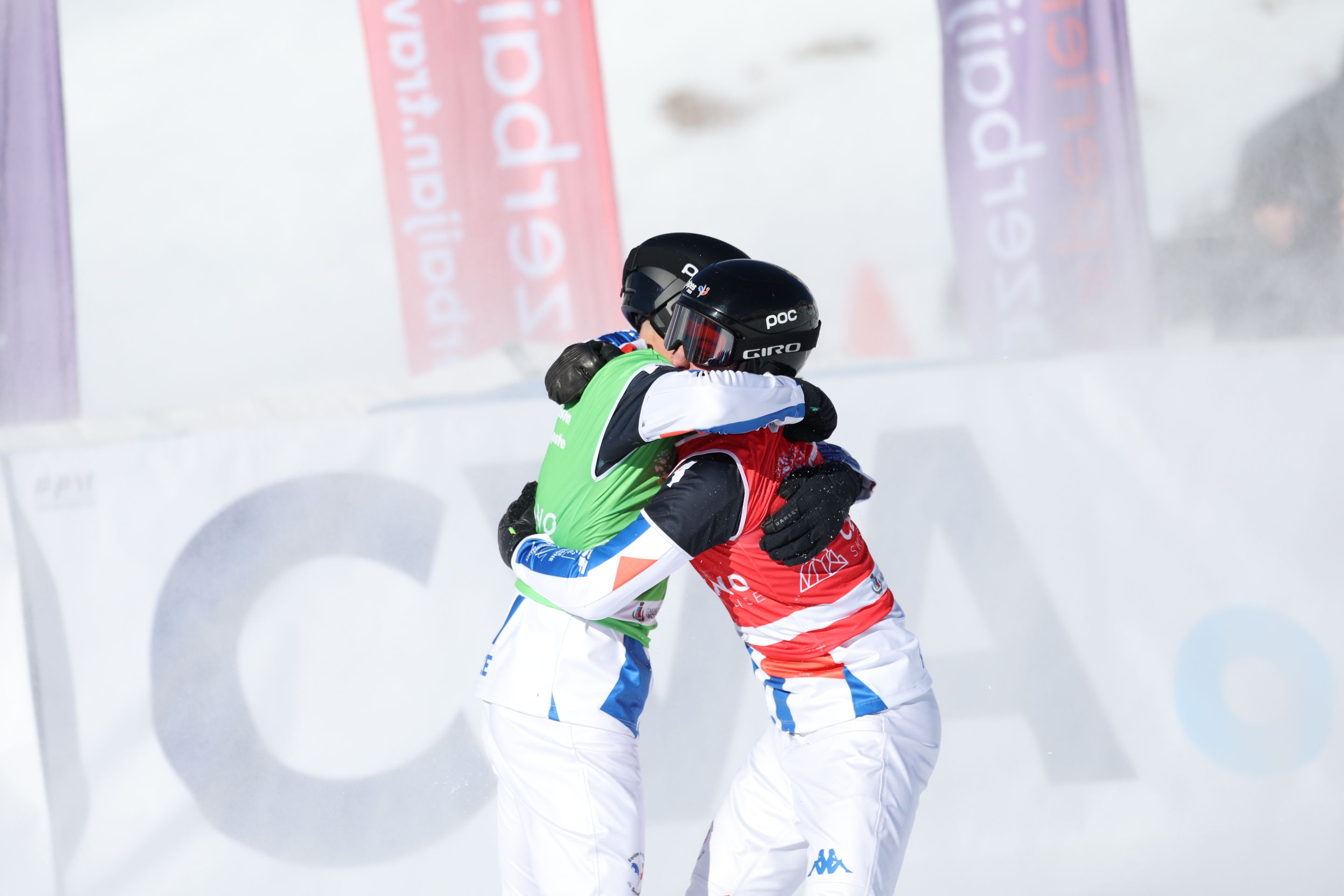 Aidan Chollet, in a green bib, and his brother Jonas, in red,  embrace after the big final in Cervinia