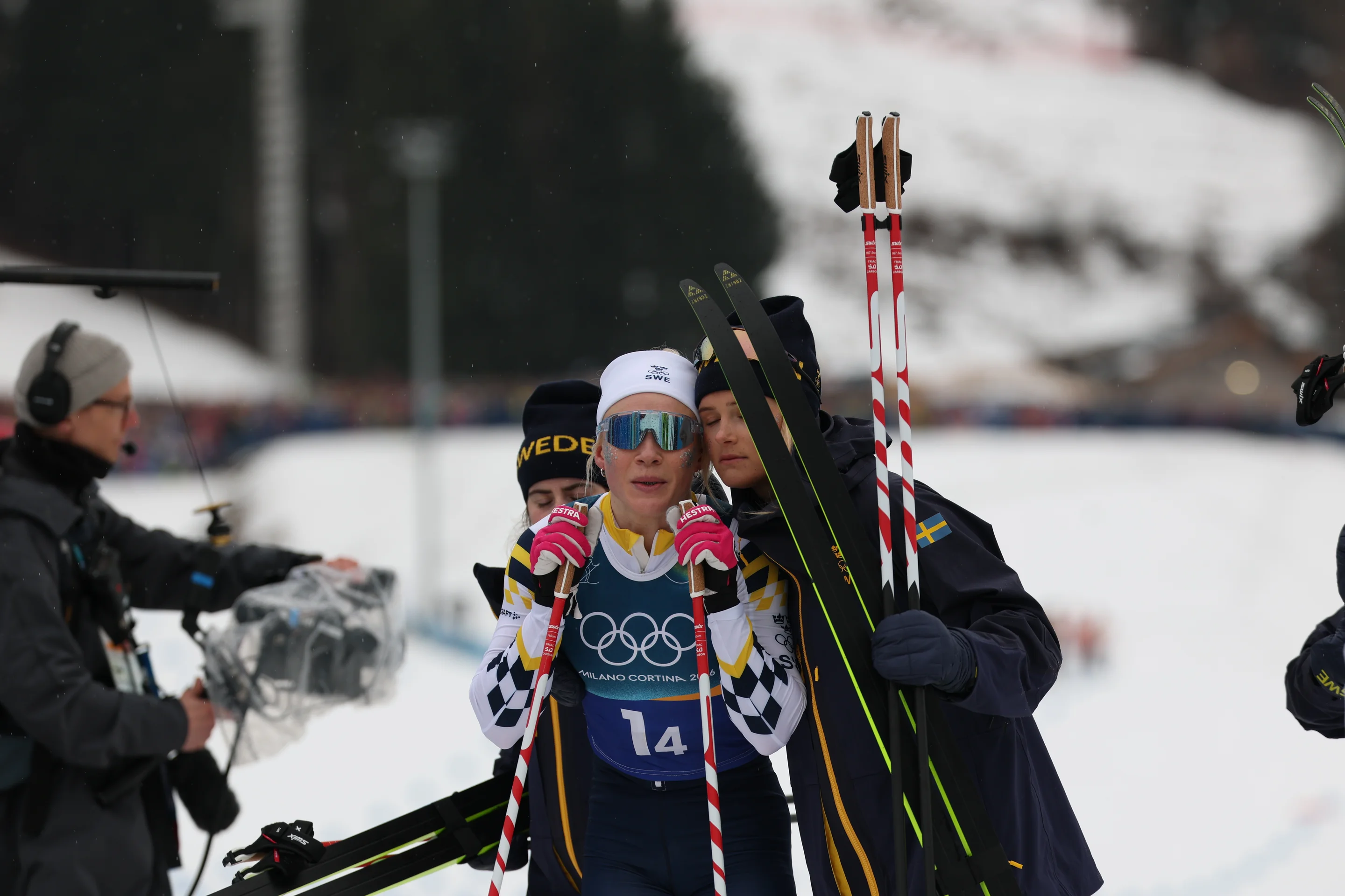 Jonna Sundling, center, is consoled by team-mates Ebba Andersson and Frida Karlsson at the finish line