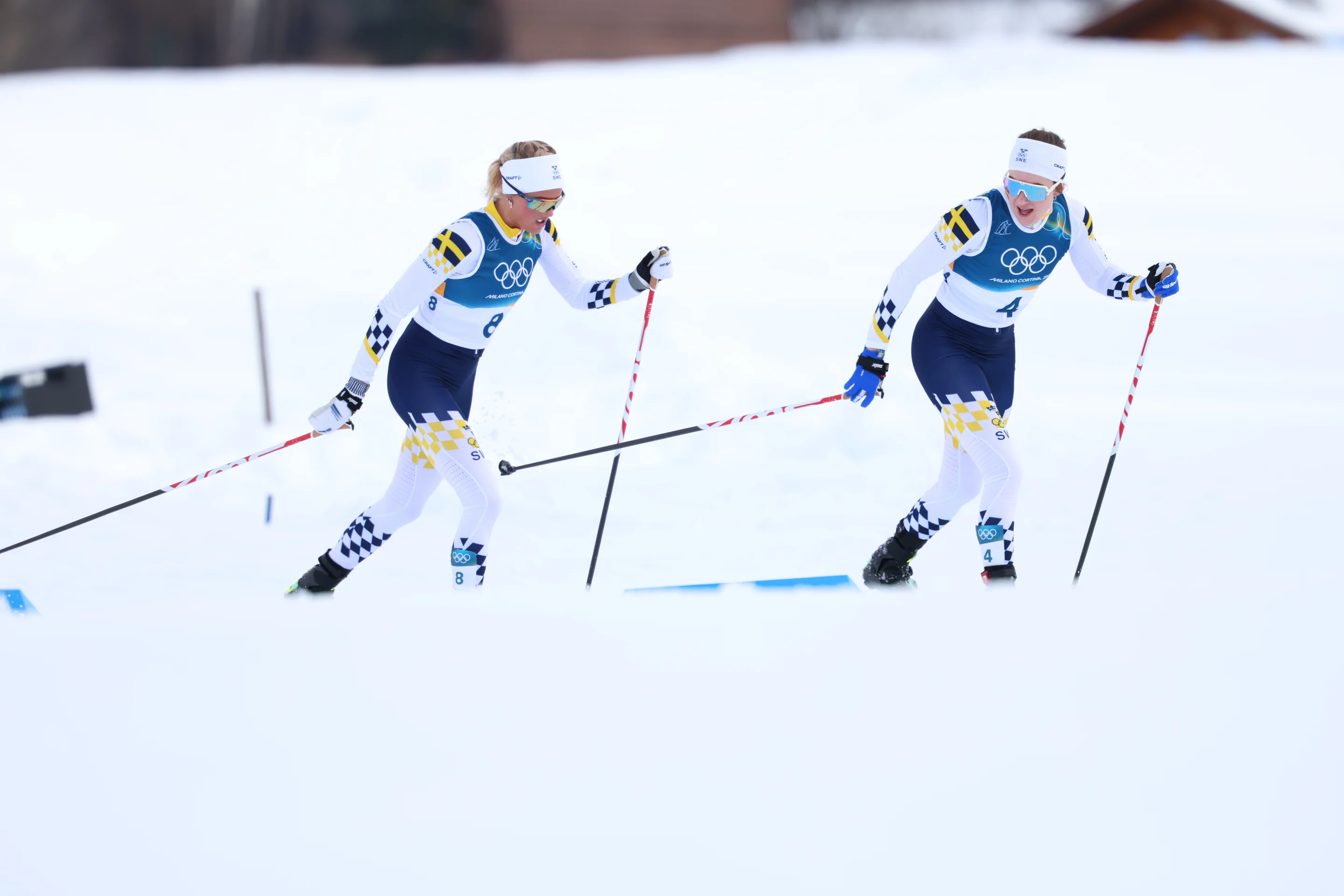 Frida Karlsson, left, and Ebba Andersson talk during the Skiathlon race