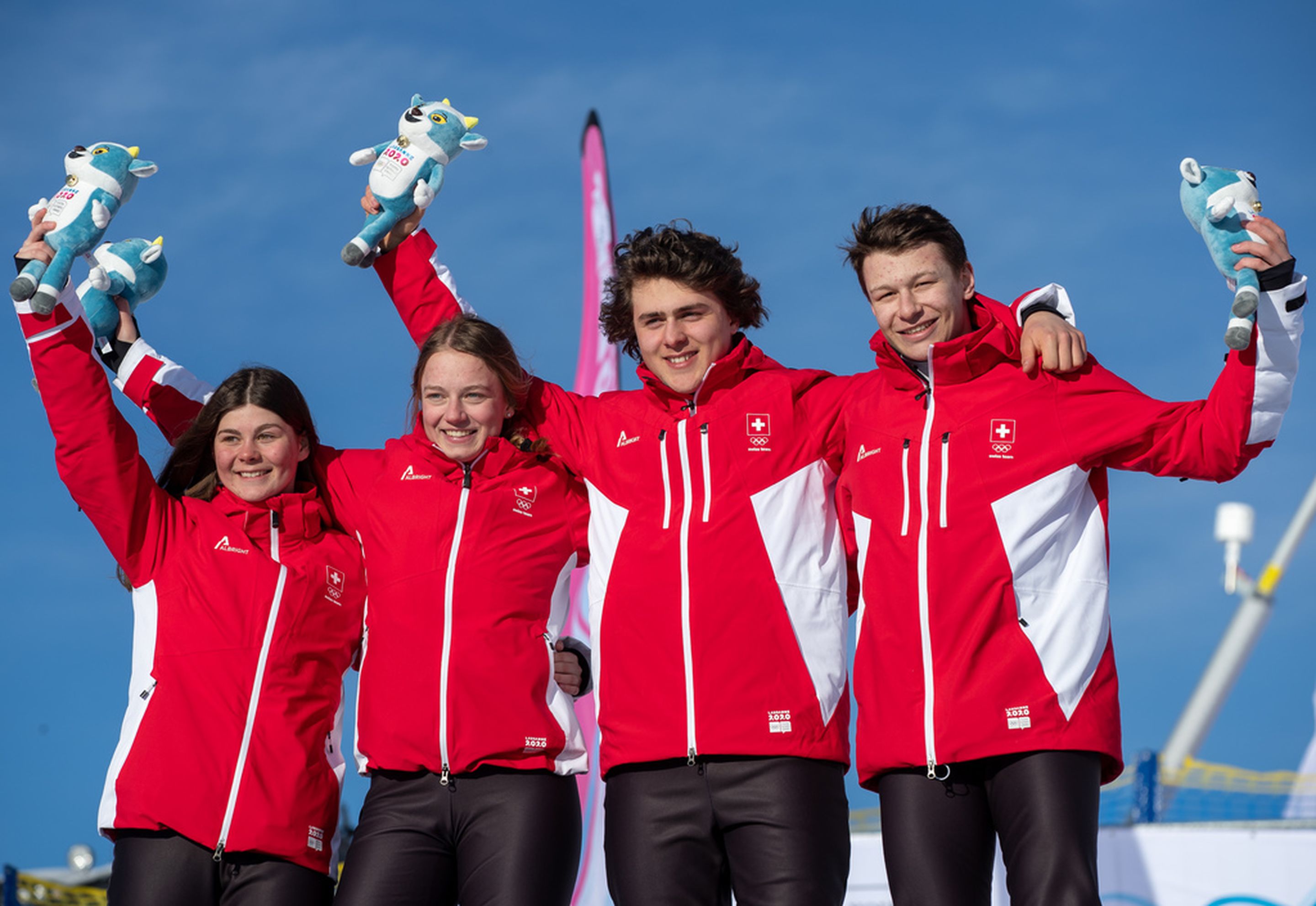 Anouk Doerig, Marie Krista, Valerio Jud and Robin Tissieres celebrate their gold medals at the Mascot Ceremony for the Team Ski-Snowboard Cross at Lausanne 2020 YOG © IOS