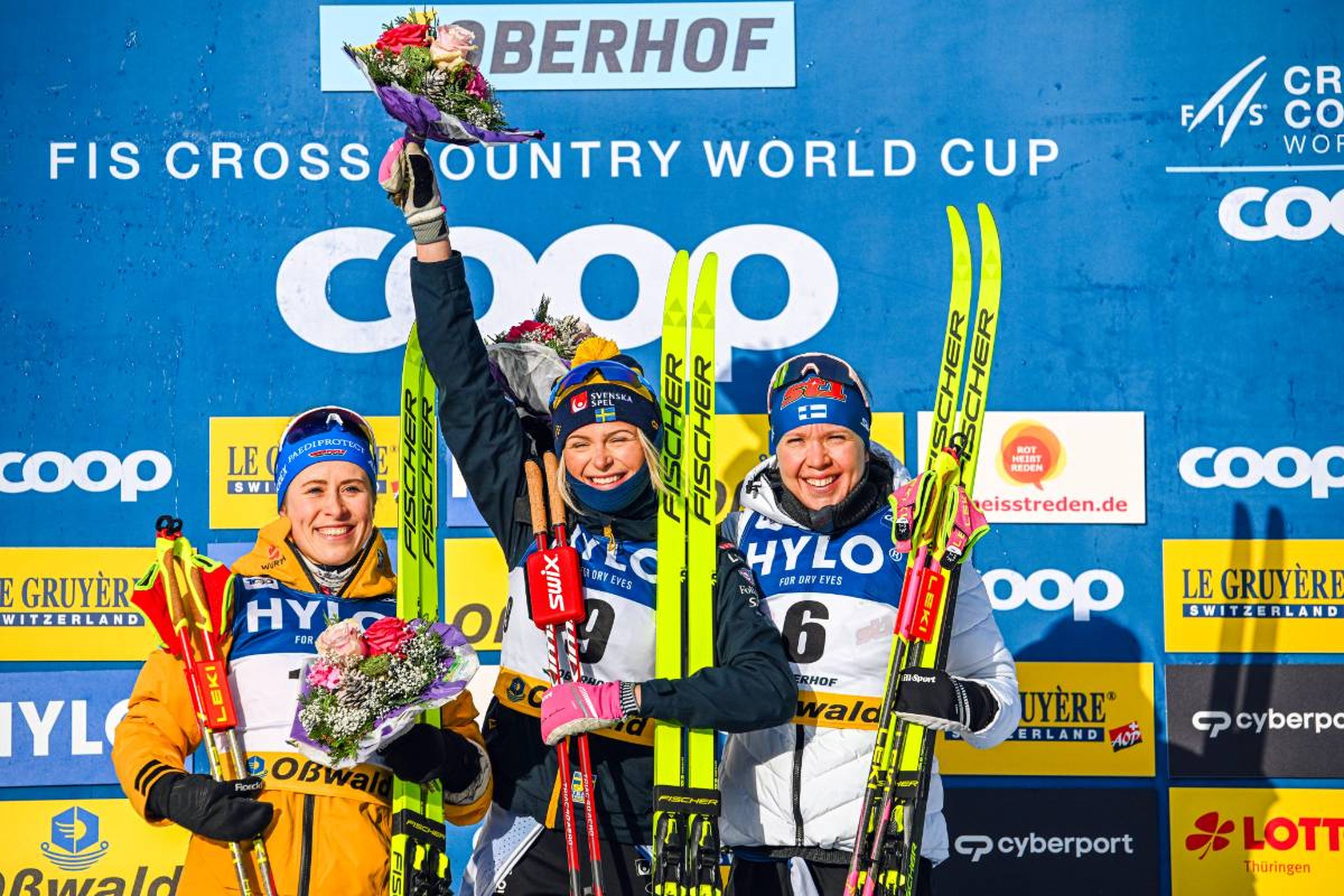Germany's Katharina Hennig (left), Sweden's Frida Karlsson (middle) and Finland's Kerttu Niskanen (right) celebrate on the podium © NordicFocus