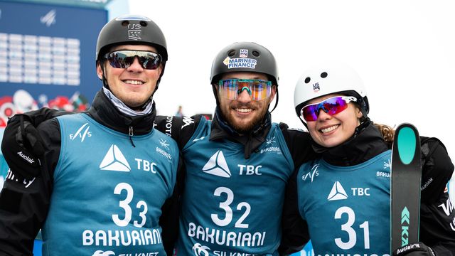 Quinn Dehlinger and Christopher Lillis with Ashley Caldwell, celebrating their gold medal win in the aerials mixed team event at the Bakuriani 2023 World Championships © Miha Matavz