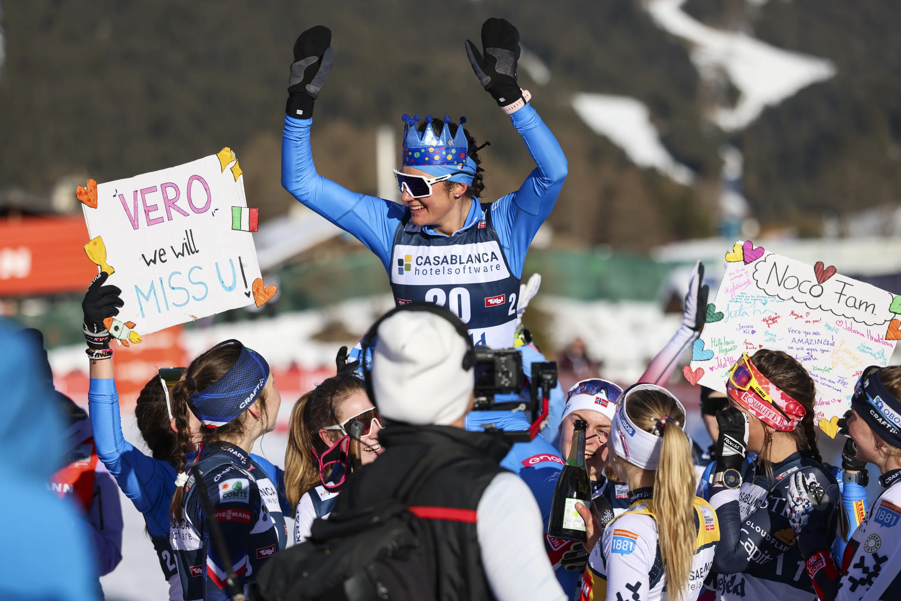 Veronica Gianmoena is held aloft by all the women's competitors while wearing a crown and surrounded by farewell banners