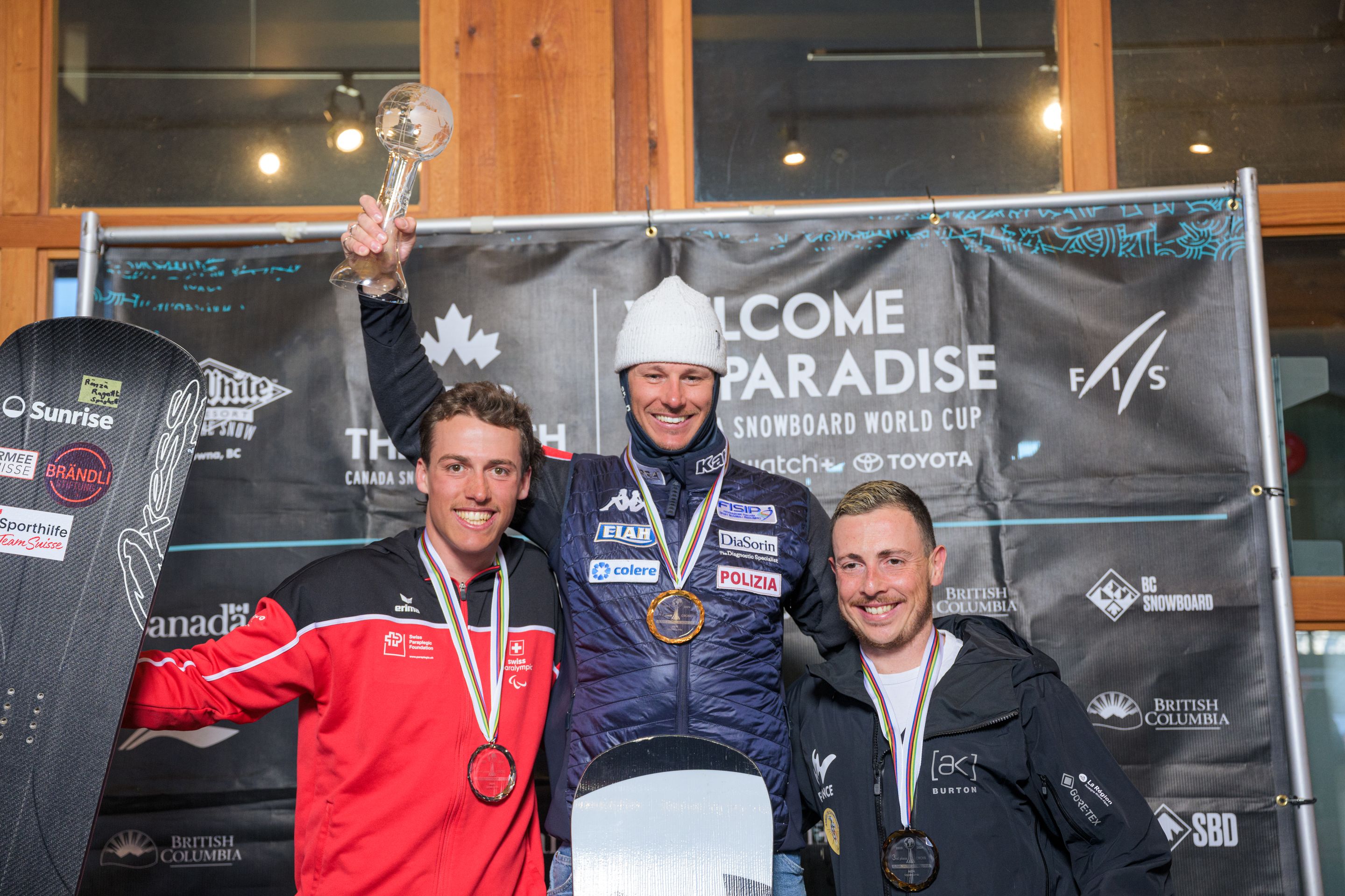 Aron Fahrni (SUI), Jacopo Luchini (ITA), lifting his crystal globe and Maxime Montaggioni (FRA)