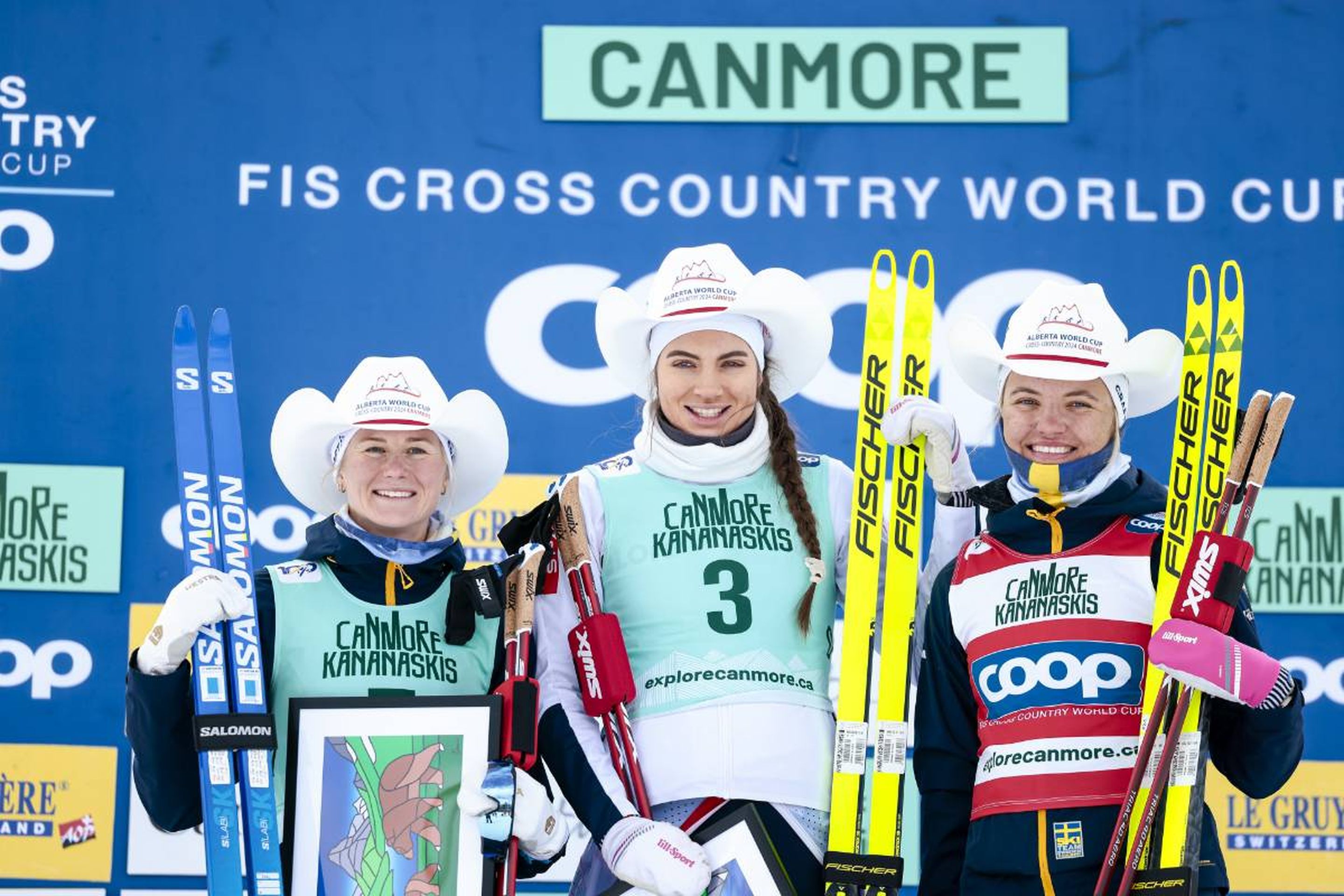 Scandies in Canada: Maja Dahlqvist (left), Kristine Stavaas Skistad (centre) and Linn Svahn (right) wearing hats on the Canmore World Cup podium © NordicFocus