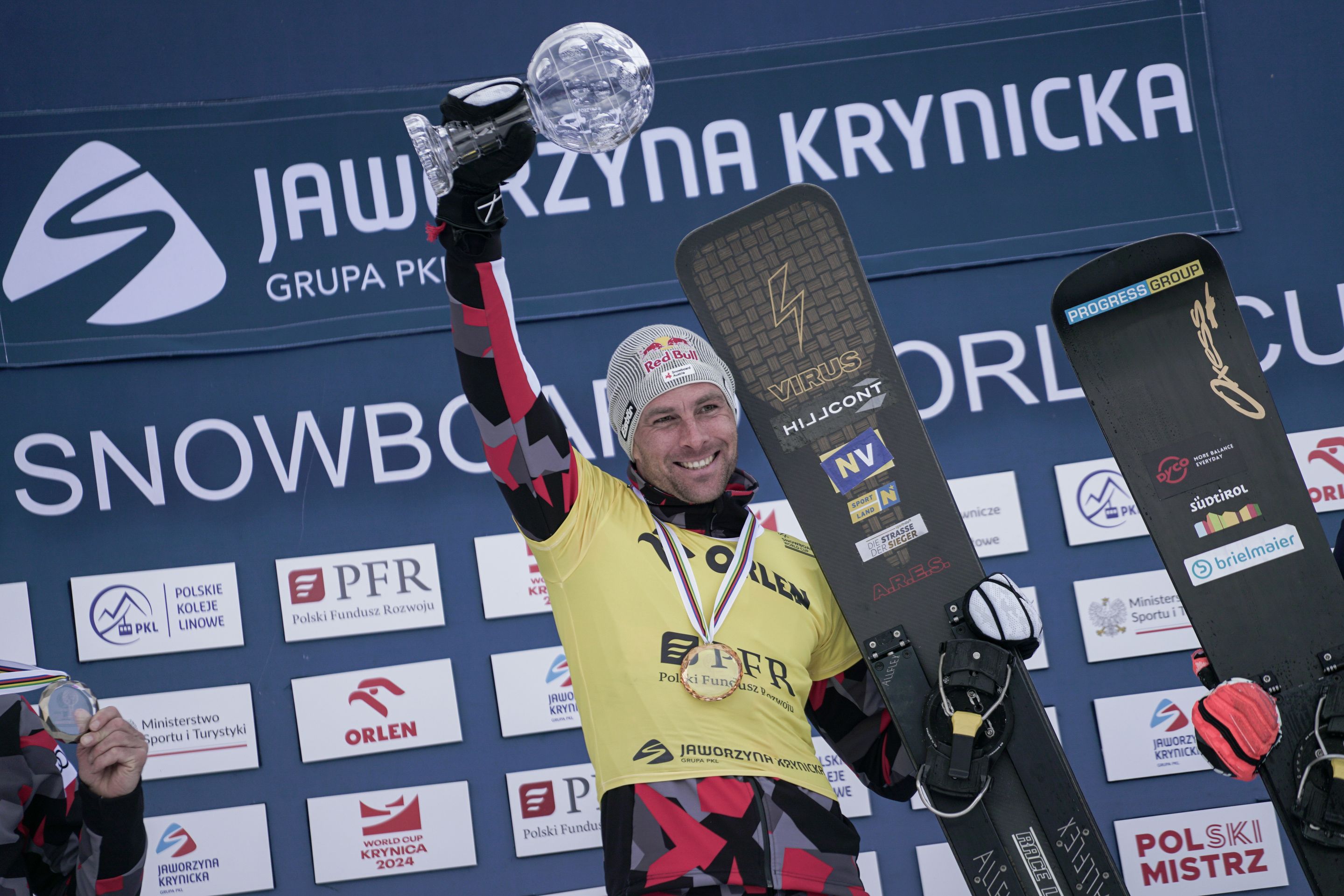 Benjamin Karl (AUT) lifts the 2023-24 PGS crystal globe. Photo: Mateusz Kielpinski/FIS